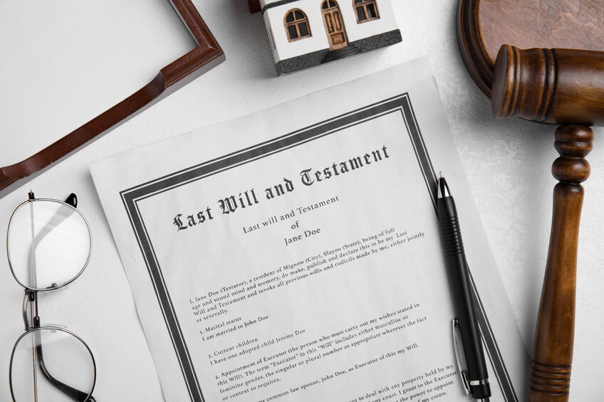 Last will and testament near house model, glasses, gavel on whit